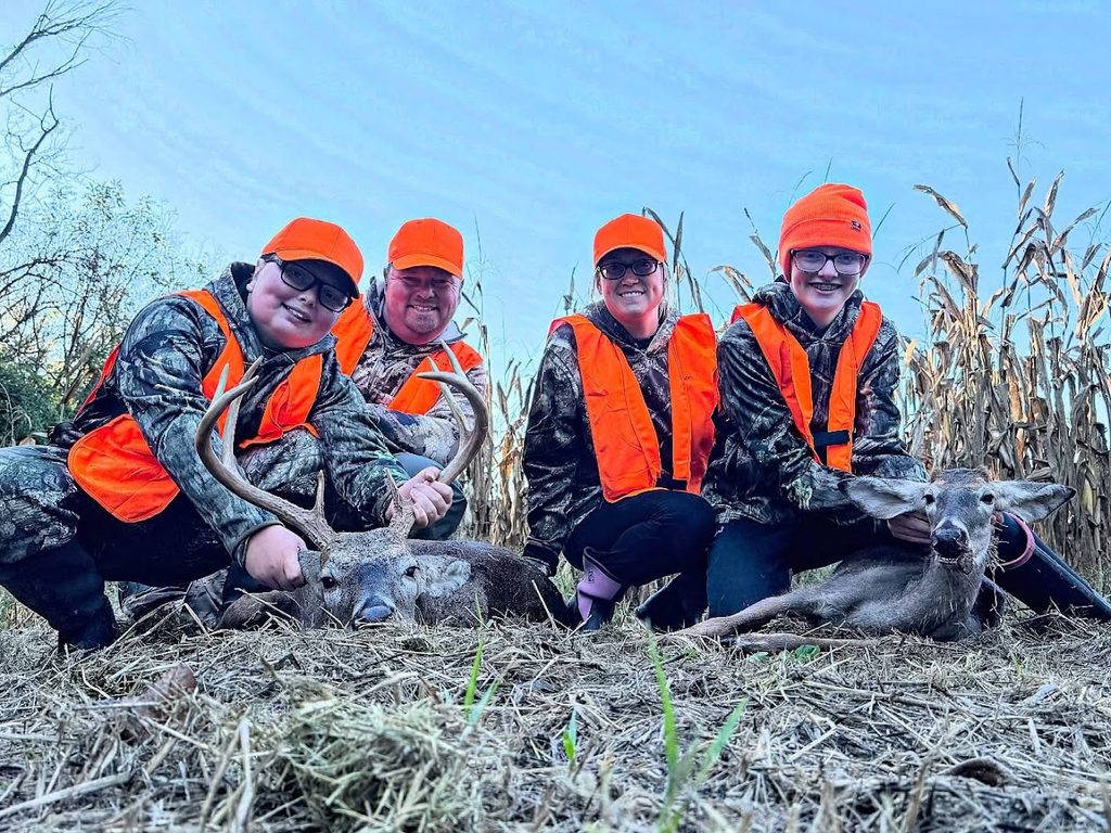 Team Moore Outdoors family deer hunting in a cornfield